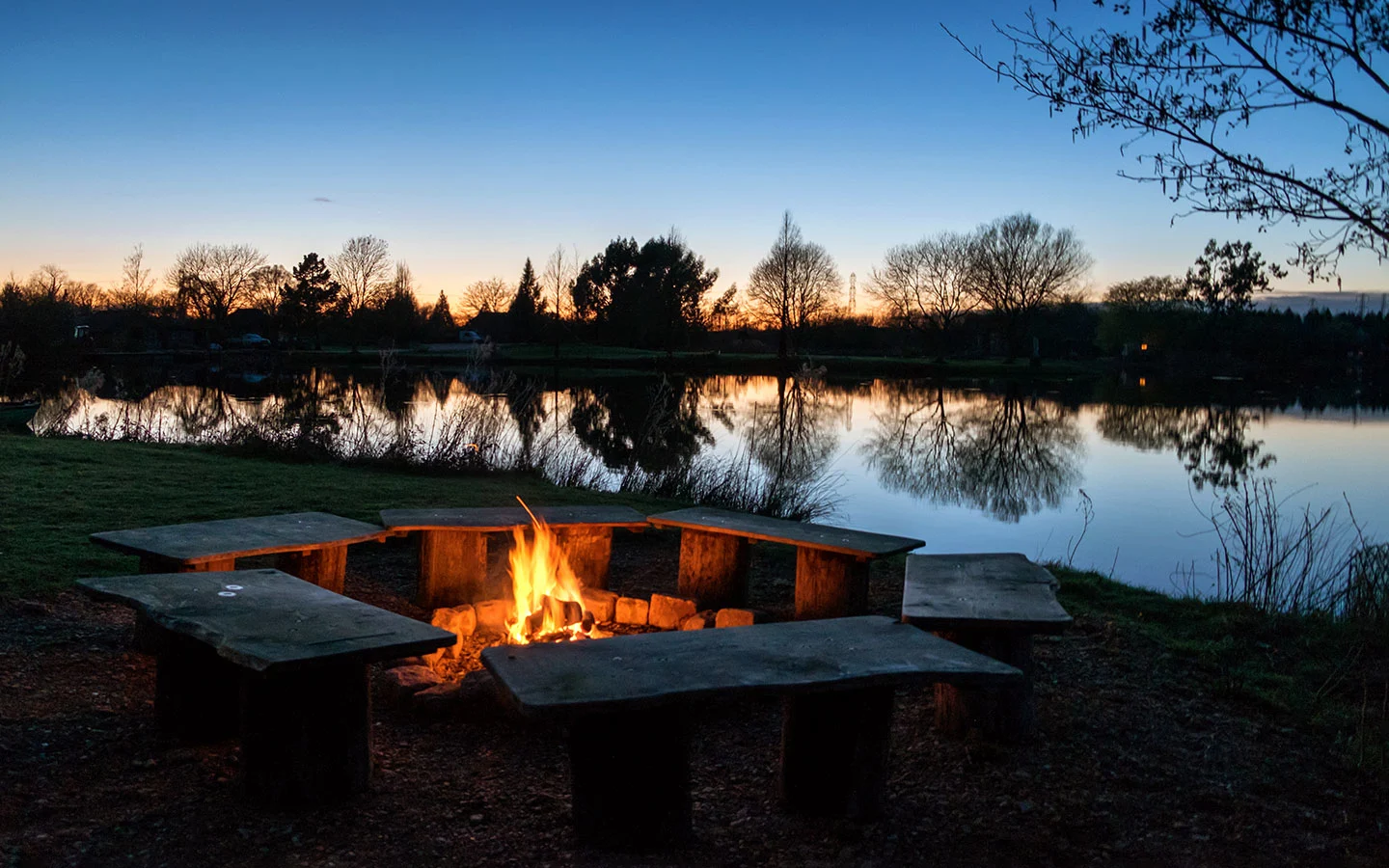 Log fire at sunset at Log House Holidays in the Cotswolds