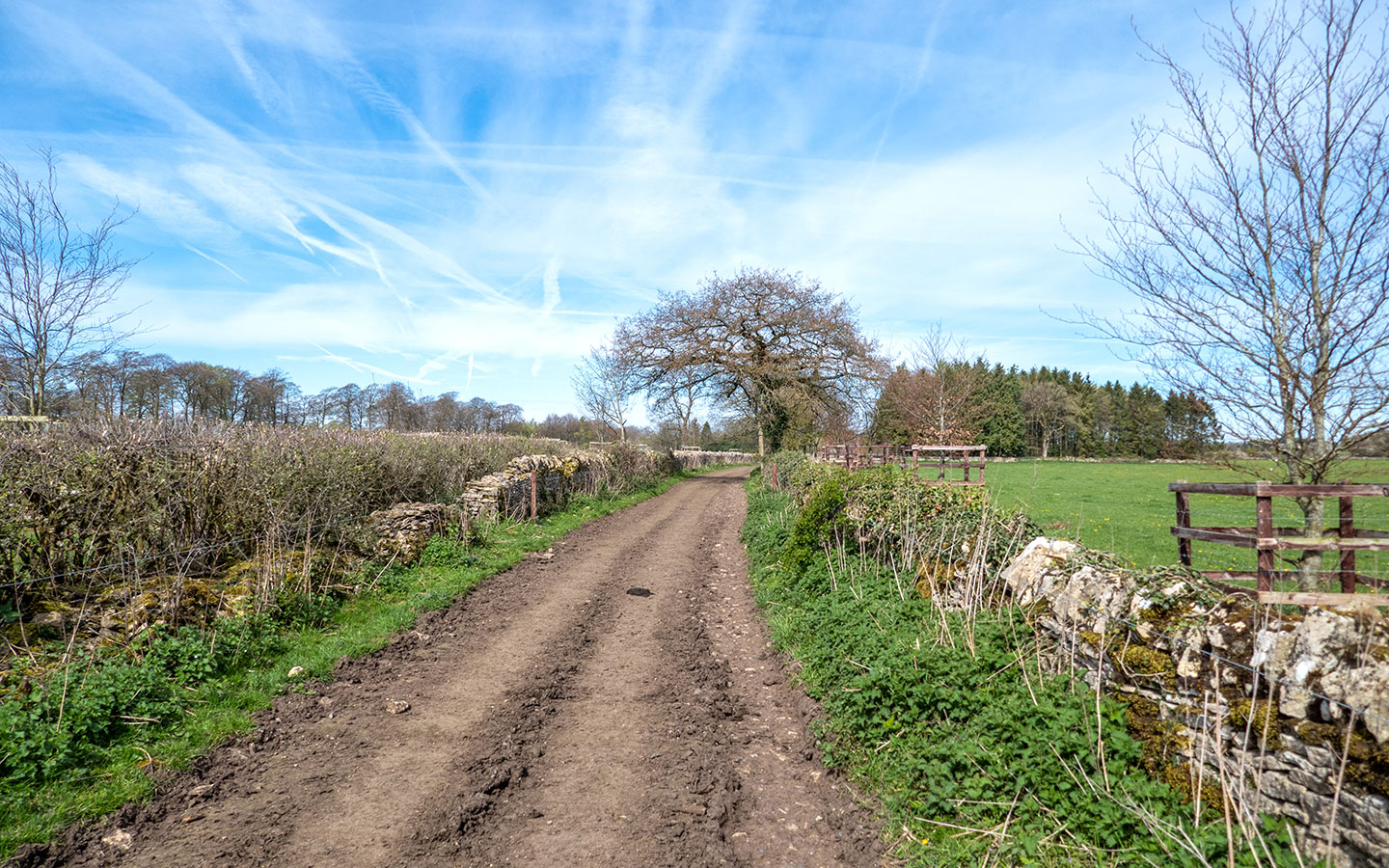 Track through farm on the Chedworth to Withington walk in the Cotswolds