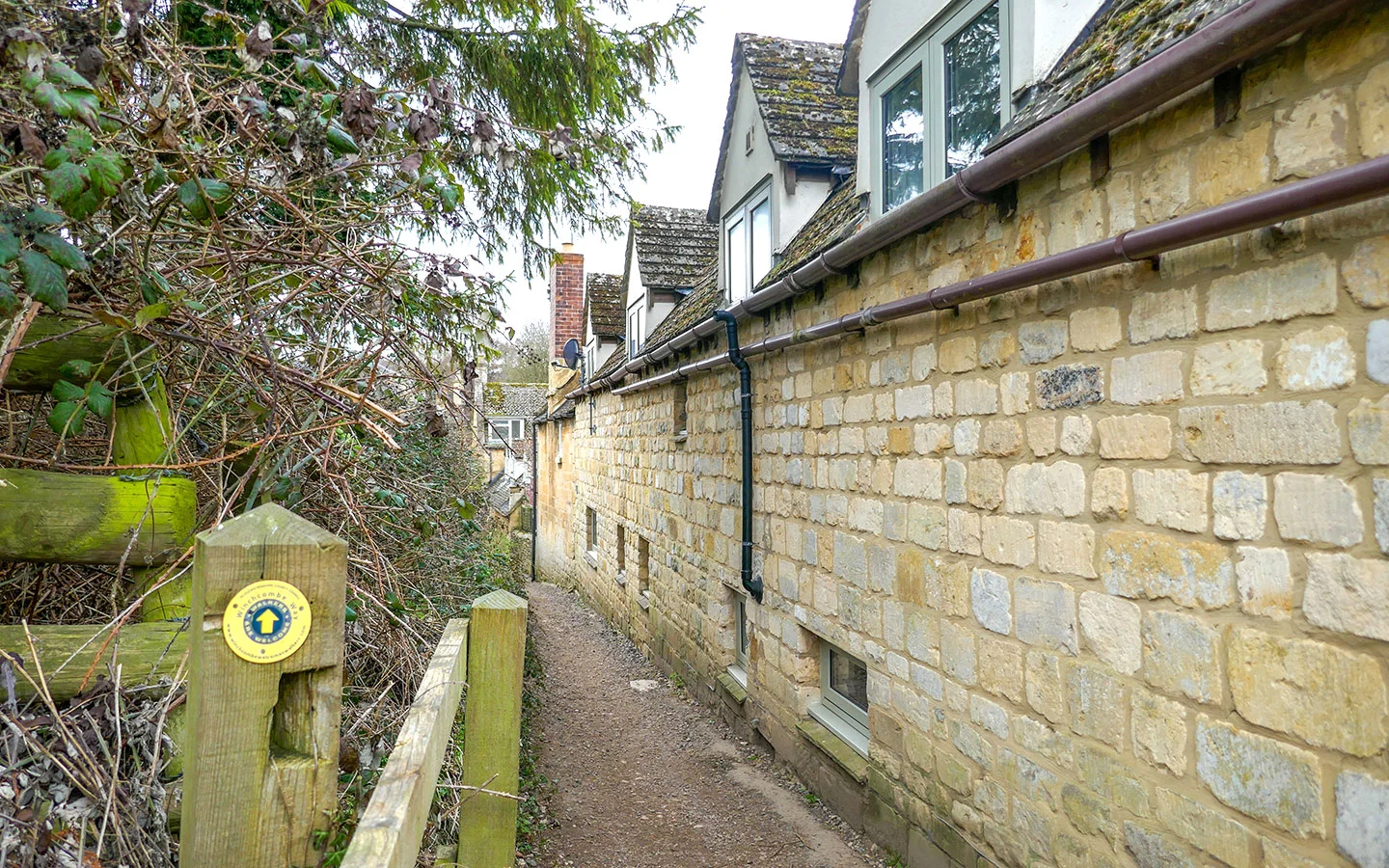 Narrow footpath next to houses leading into Winchcombe