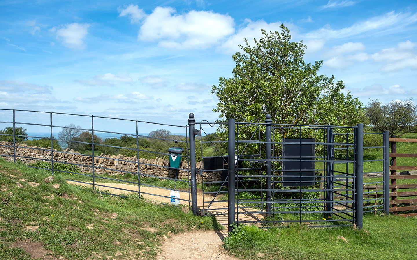 Black kissing gate onto the Cotswold Way behind the Broadway Tower