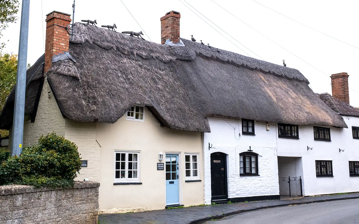 Old Fox Cottage with its rooftop fox family of straw finials